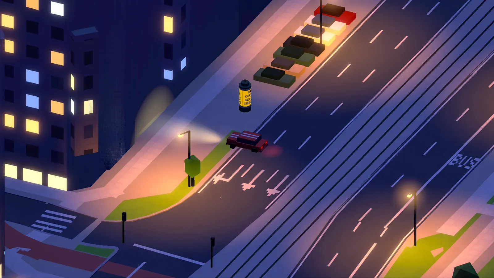 A small car on a lamp-lit street at night next to an advertising column